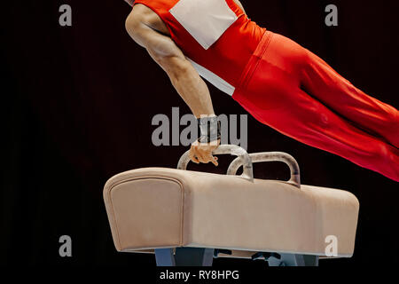 exercise pommel horse athlete gymnast on black background Stock Photo