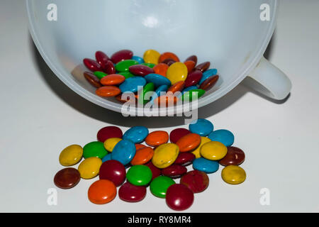 colorful coated chocolate candies in a cup. Stock Photo