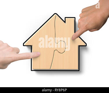 Woman and man two hands assembling wooden house shape puzzles, high angle view, isolated on white background. Stock Photo