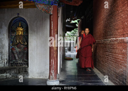 Chinese monks walking around stupa, Wutai Shan, Shanxi, China Stock Photo