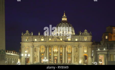 View of the Basilica of Saint Peter in Rome Italy at night with the lights around the square and the people outside Stock Photo
