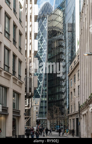 Glass and steel of the City of London's towers loom over City workers in Lime Street. Stock Photo