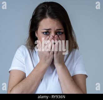 Close up of young woman feeling scared and shocked making fear, anxiety gestures. Looking terrified and desperate. People and Human expressions and em Stock Photo