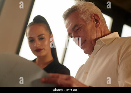 Low angle view of colleagues discussing blueprint in office Stock Photo