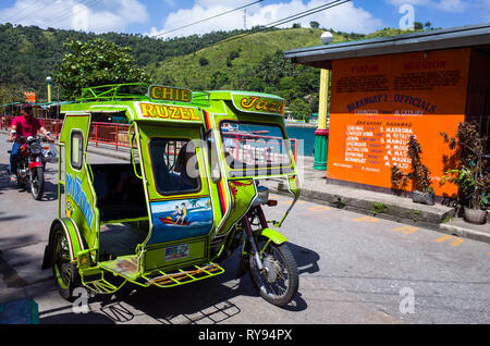 Colorful Tricycle Taxi, a motorbike with sidecar that's an iconic part of Filipino Culture - Romblon Island, Philippines Stock Photo