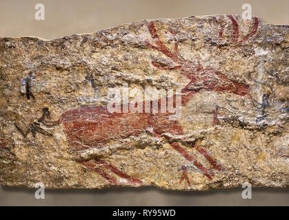 Fresco of human figures around a deer. None of the figures carry weapons and some a dressed in leopard costumes. The figures seem to be trying to hold Stock Photo