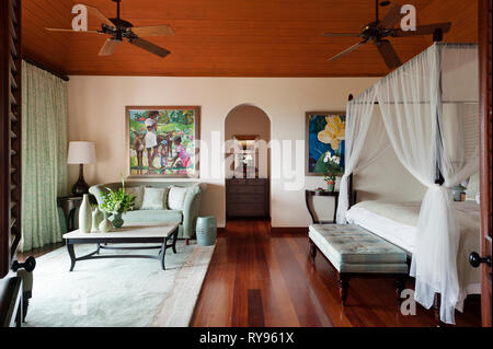 'Rustic bedroom with four poster bed in Tamarind Cove, Antigua' Stock Photo