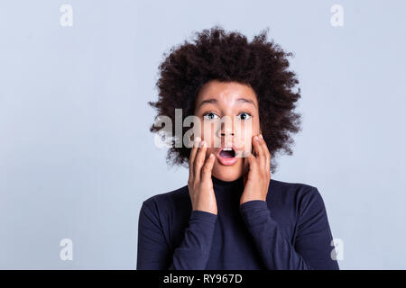 Pretty African American boy playing on camera and touching his face Stock Photo