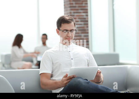modern man uses a digital tablet for reading Stock Photo