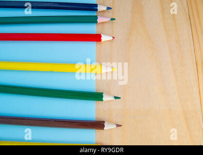 Flat lay, colored pencils, blue and wooden background, back to school, copy space Stock Photo