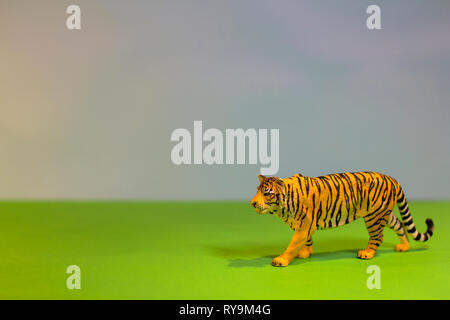 Like a real tiger. Toy tiger on a bright studio background. Eco toys. Stock Photo