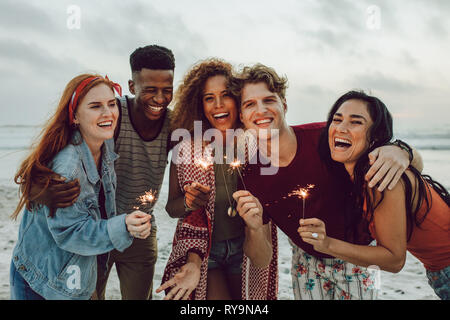 Group of friends enjoying beach party stock photo