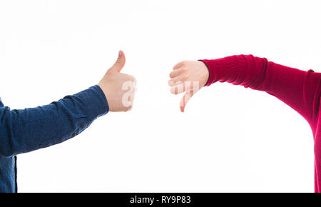 Close up of man and woman hands giving thumbs up and down, positive vs negative gesture isolated on white. Like and dislike symbol, business disagreem Stock Photo