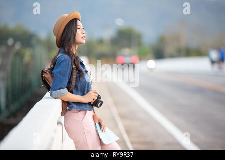 Female tourists spread their arms and held their wings, smiling happily. Stock Photo