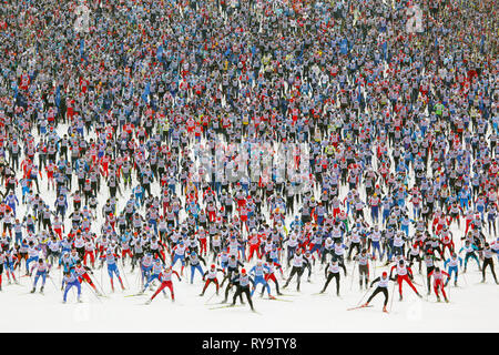 Large group of sportsmen running winter ski marathon Stock Photo