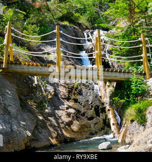 bridge over a mountain river and stony bank