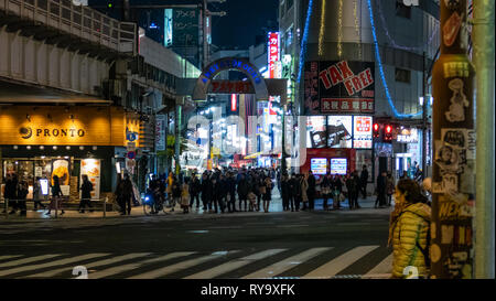 TOKYO, JAPAN - FEBRUARY 7, 2019: People in Ameyoko or Ameyayokocho market near Ueno station. A major shopping street in Tokyo. Japanese text advertise Stock Photo