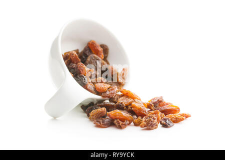 Dried raisins in bowl isolated on white background. Stock Photo
