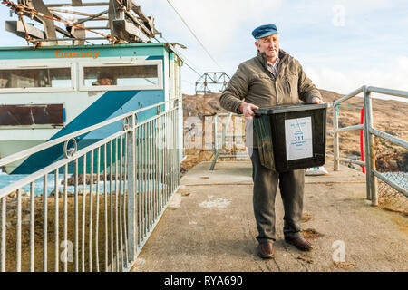 Dursey Island, Cork, Ireland. 26th February, 2016. Islander Gerard Murphy arrives on to the island from the mainland with the ballot box for Ireland's Stock Photo