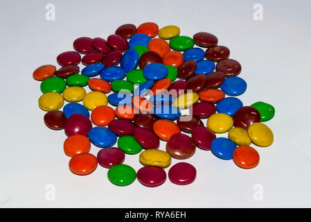 colorful coated chocolate candies on a white background. Stock Photo