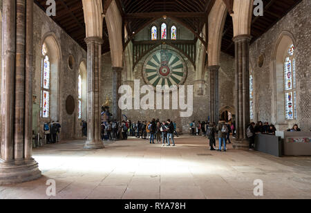 Winchester, Hampshire, England, UK, Students on an educational vitsit to the historic Great Hall. King Arthurs Round Table is mounted on the wall. Stock Photo