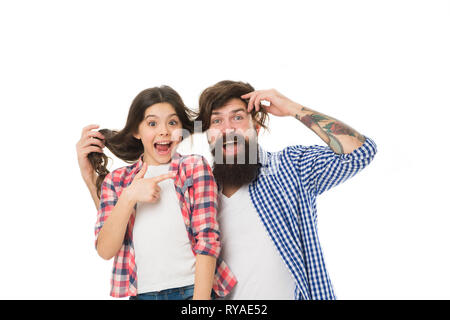 He envies my hairstyle. Man with beard and little girl long hair on white background. Father play with hair of kid. Hairdresser and barber concept. Ha Stock Photo