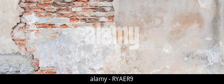 Old grungy red brick wall with peeled white beige stucco banner background. Vintage retro plaster wall with dirty cracked scratched texture background Stock Photo