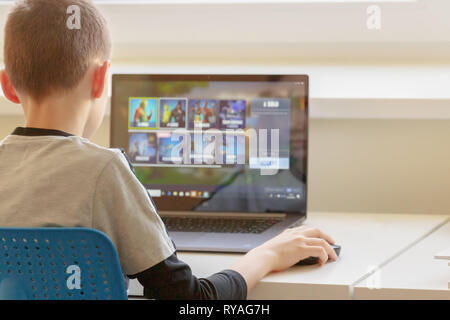 Boy playing Fortnite game. Fortnite is online video game developed by Epic Games Stock Photo