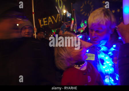 Mr Johnson scolds Mrs May: A Pro-remain demonstrator and Boris Johnson doppelganger converses with a Theresa May puppet during the demonstrations in opposition to Brexit on the evening on the Meaningful Vote on Brexit. Stock Photo