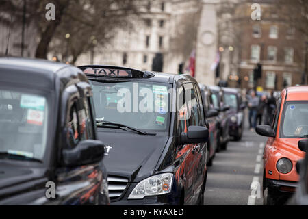LONDON, UK - March 13th 2019: Black cabs block roads around Westminster in protest over plans to ban them driving on roads in parts of London Credit: Ink Drop/Alamy Live News Stock Photo
