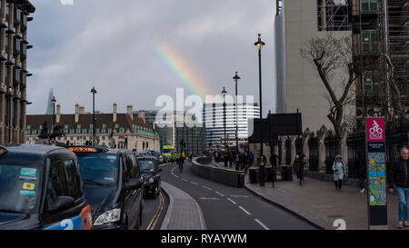 London, UK.  13 March 2019.  UK Weather - a rainbow is seen over Westminster Bridge after rain shower in the capital.  Credit: Stephen Chung / Alamy Live News Stock Photo