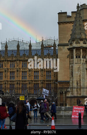 London, UK. 13th Mar, 2019. 13th March 2019 A rainbow shines over the palace of Westminster.   Brexit campaigners outside the Palace of Westminster on the day Prime minister May loses the vote and removes No Deal from the Brexit negotiations Credit: Thomas Bowles/Alamy Live News Stock Photo