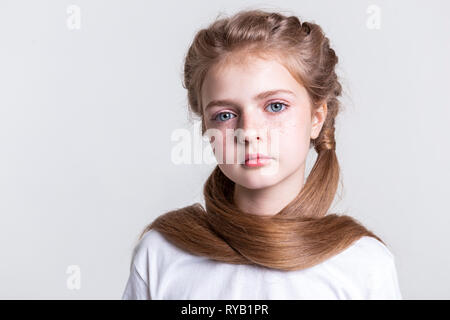 Appealing good-looking young girl covering herself with long hair Stock Photo