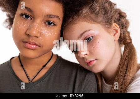 Pretty young kids having their freckles painted on Stock Photo