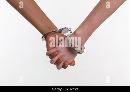 Desperate little kids covered in metal handcuffs binding fingers Stock Photo