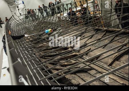 Views of surviving timbers from longest Viking warship ever found displayed in the UK for the first time. The timbers have been painstakingly fitted together like a huge jigsaw and placed inside an actual size steel cradle . The reconstruction work is by members National Museum of Denmark who have come over to the Museum especially.     The 37 metre long ship will form the centrepiece of the British Museum's BP exhibition, Vikings: life and legend.  The ship, known as Roskilde 6, was excavated from the banks of Roskilde fjord in Denmark during the course of work undertaken to develop the Roski Stock Photo