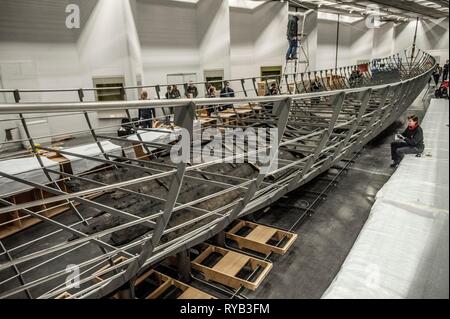 Views of surviving timbers from longest Viking warship ever found displayed in the UK for the first time. The timbers have been painstakingly fitted together like a huge jigsaw and placed inside an actual size steel cradle . The reconstruction work is by members National Museum of Denmark who have come over to the Museum especially.     The 37 metre long ship will form the centrepiece of the British Museum's BP exhibition, Vikings: life and legend.  The ship, known as Roskilde 6, was excavated from the banks of Roskilde fjord in Denmark during the course of work undertaken to develop the Roski Stock Photo