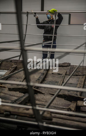 Views of surviving timbers from longest Viking warship ever found displayed in the UK for the first time. The timbers have been painstakingly fitted together like a huge jigsaw and placed inside an actual size steel cradle . The reconstruction work is by members National Museum of Denmark who have come over to the Museum especially.     The 37 metre long ship will form the centrepiece of the British Museum's BP exhibition, Vikings: life and legend.  The ship, known as Roskilde 6, was excavated from the banks of Roskilde fjord in Denmark during the course of work undertaken to develop the Roski Stock Photo