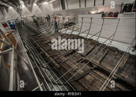 Views of surviving timbers from longest Viking warship ever found displayed in the UK for the first time. The timbers have been painstakingly fitted together like a huge jigsaw and placed inside an actual size steel cradle . The reconstruction work is by members National Museum of Denmark who have come over to the Museum especially.     The 37 metre long ship will form the centrepiece of the British Museum's BP exhibition, Vikings: life and legend.  The ship, known as Roskilde 6, was excavated from the banks of Roskilde fjord in Denmark during the course of work undertaken to develop the Roski Stock Photo