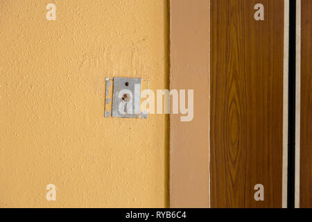 Old elevator call button with grungy pattern in a soviet building in post-soviet Riga, Latvia Stock Photo