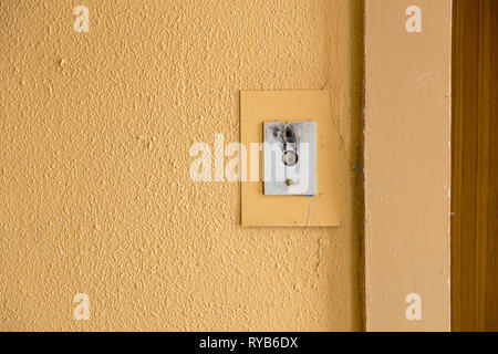 Old elevator call button with grungy pattern in a soviet building in post-soviet Riga, Latvia Stock Photo