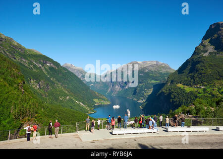 Tourists looking out over Geirangerfjord from Flydalsjuvet viewpoint in Geiranger, Sunnmøre, Møre og Romsdal county, Norway, Scandinavia Stock Photo