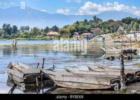 Santiago Atitlan, Lake Atitlan, Guatemala - March 8, 2019: Rows of lakeside traditional canoes by lake in largest lakeside town Stock Photo