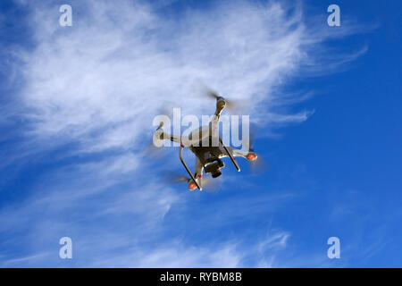 Quadcopter drone, UAV, in flight Stock Photo