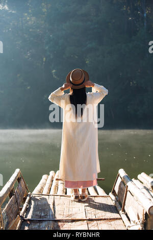 Female tourists spread their arms and held their wings, smiling happily. Stock Photo