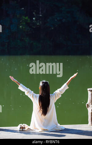 Female tourists spread their arms and held their wings, smiling happily. Stock Photo