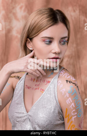 Serious pleasant nice woman touching her cheek Stock Photo