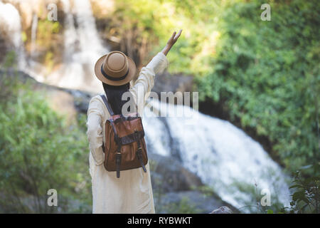 Female tourists spread their arms and held their wings, smiling happily. Stock Photo