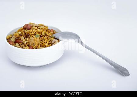 Photo of mix namkeen with spoon. Isolated on the white background. Stock Photo