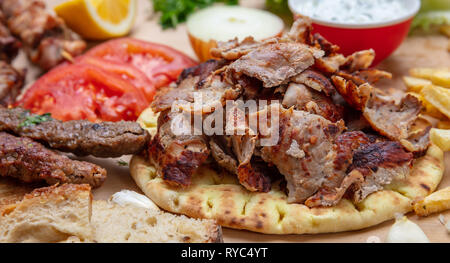 Shawarma, gyros pita, kebab. Traditional turkish, greek meat food on pita bread, closeup view Stock Photo